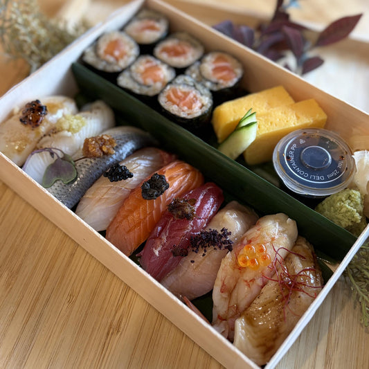 Chef's Selection with Maki: assorted nigiri, salmon hosomaki and tamago in a wooden box