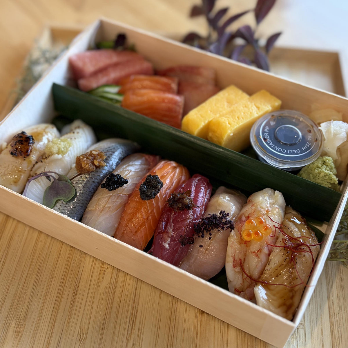 Chef's Selection with Sashimi: assorted nigiri, sashimi and tamago in a wooden box