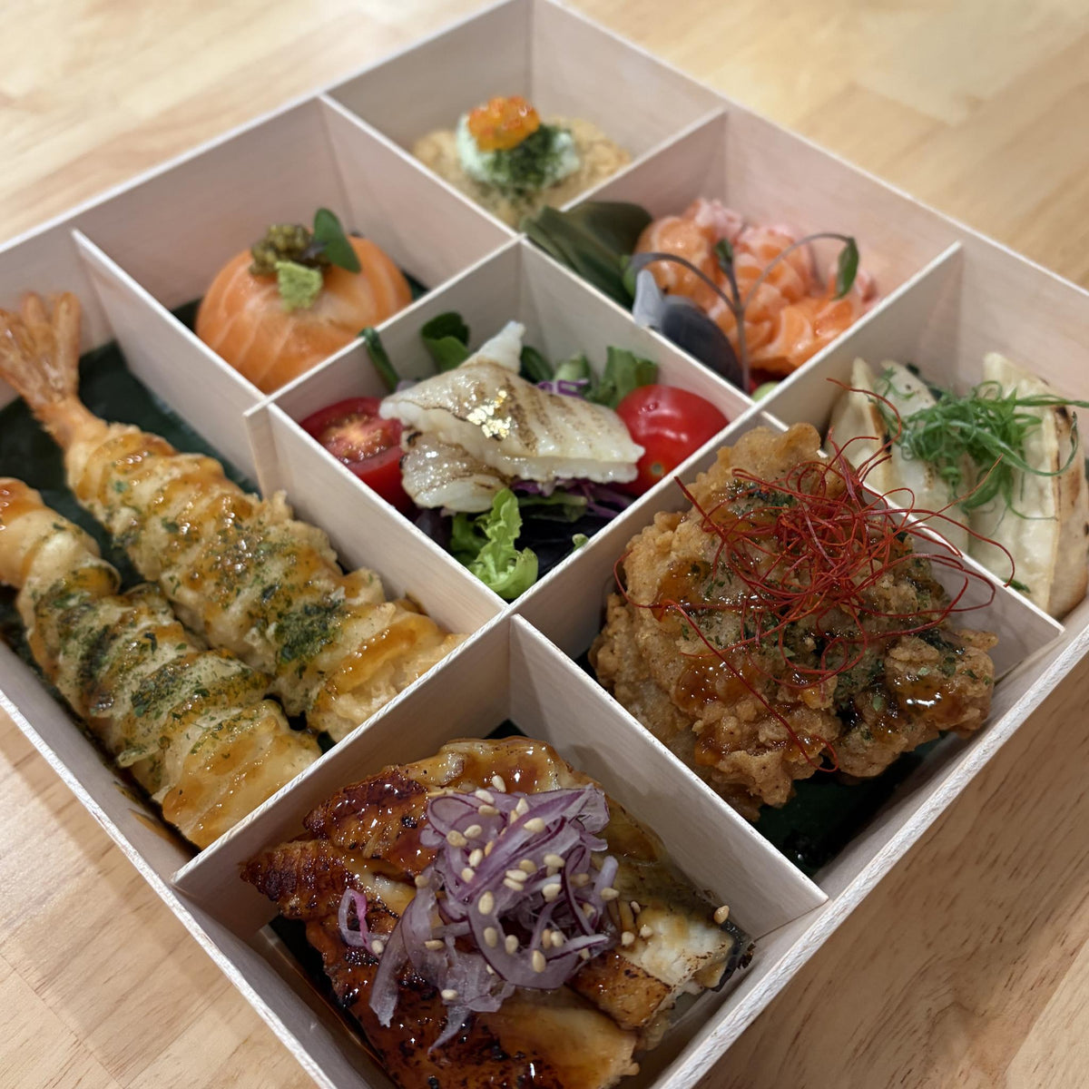 Omakase double box extras: prawn tempura, salmon temari, engawa salad, salmon sashimi, gyoza and karaage